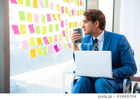 Young handsome man in wheelchair with many conflicting prioritie Young handsome man in wheelchair with many conflicting prioritie 45949704