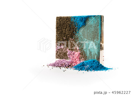 A square golden cosmetic box with colored eye shadows flowing from its lid. 45962227