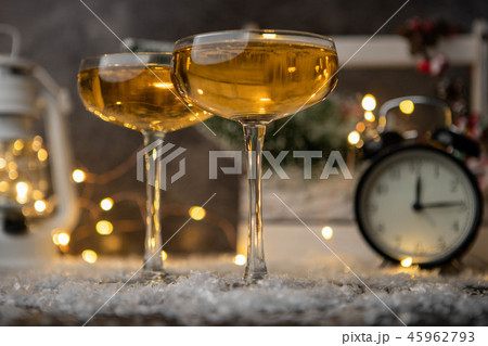 Picture of two wine glasses on blurred background with Christmas tree, lantern, clock 45962793