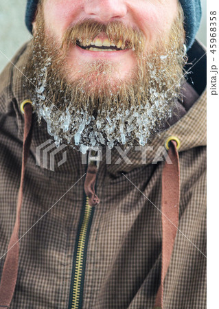 Smiling young man with beard in icicles 45968358