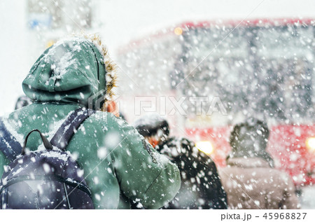 Back view of man in hood in blizzard 45968827