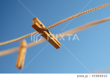 Clothespins on a clothesline against a blue sky 45968910