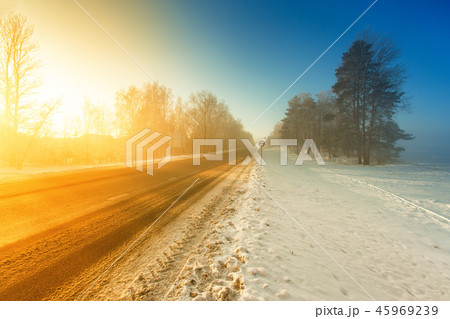 Winter misty highway road in morning sunlight Winter misty highway road in morning sunlight 45969239
