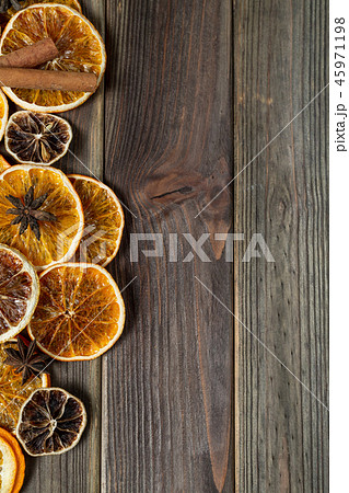 Dry slices of orange on broom wooden background 45971198