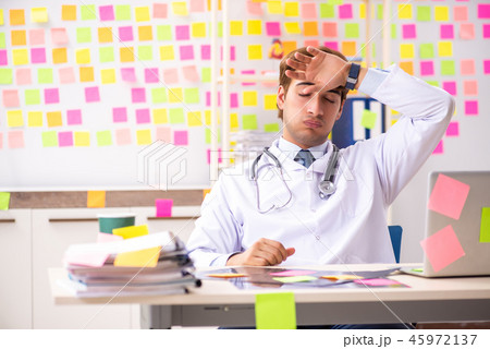 Male doctor with many conflicting prioritites Male doctor with many conflicting prioritites 45972137