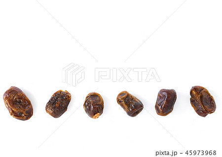 Dried halawi dates on a white 45973968