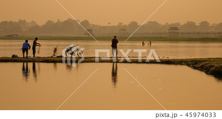 Catching fish on lake at sunrise 45974033