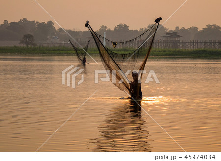 Catching fish on lake at sunrise 45974034