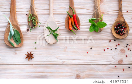 Various of spices and herbs in wooden spoons. Various of spices and herbs in wooden spoons. 45977534
