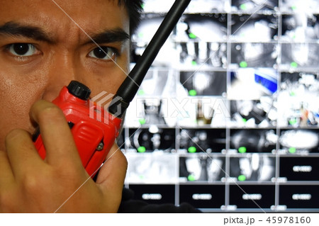 man and radio communicationblurred cctv monitor 45978160