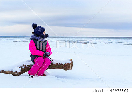 Teenage girl walking on sea shore Narva Estonia 45978367
