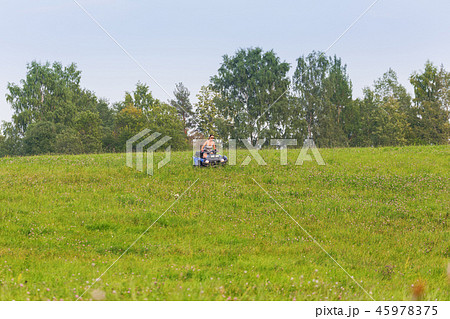 Elegant woman riding quadrocycle on spring field Elegant woman riding quadrocycle on spring field 45978375