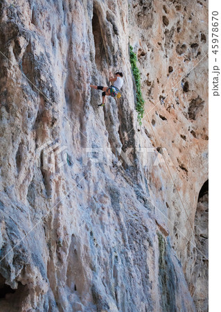 woman rock climbing on karst white mountain woman rock climbing on karst white mountain 45978670