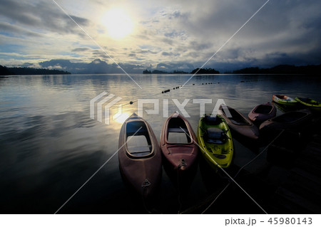 Beautiful lake with sunrise and kayaks in Thailand Beautiful lake with sunrise and kayaks in Thailand 45980143
