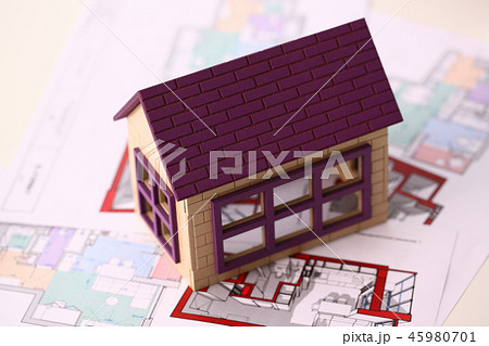 Small miniature house stands on drawing 45980701