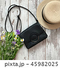 Women's black handbag on a wooden background 45982025