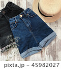 Female blue denim shorts on a wooden background 45982027