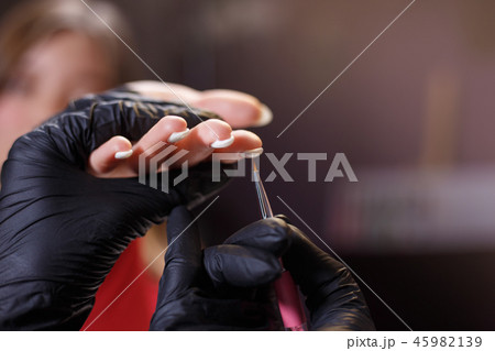 manicure procedure at beauty salon, nails care 45982139