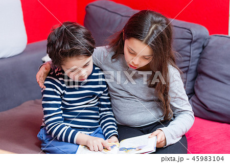 Brother and sister reading story book Brother and sister reading story book 45983104