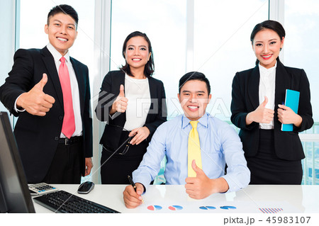 Successful businesspeople showing thumbs up sign 45983107