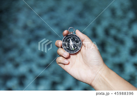 Hand holding compass Hand holding compass 45988396