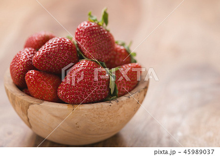 Ripe strawberries in wooden bowl on wood background with copy space 45989037