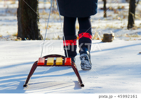 Child pulls sled broke snow snow in winter 45992161