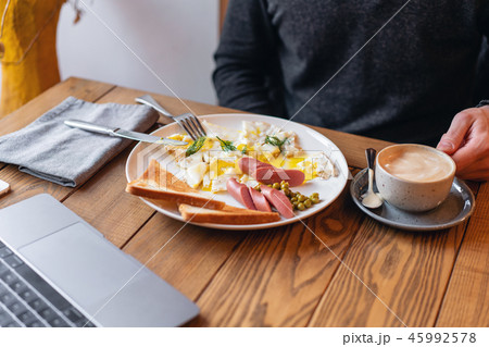 The concept of eating at work. Laptop and Breakfast on the table.. American style breakfast with 45992578