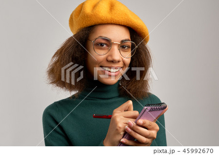 black girl smiles widely and takes notes 45992670