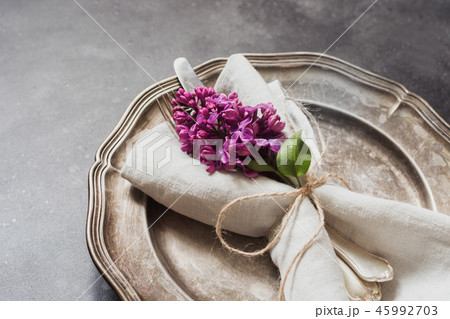 Spring elegant table place setting with lilac. Spring elegant table place setting with lilac. 45992703