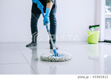 Husband housekeeping and cleaning concept, Happy young man in bl Husband housekeeping and cleaning concept, Happy young man in bl 45992812