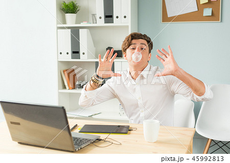 young man in suit having fun in the office young man in suit having fun in the office 45992813