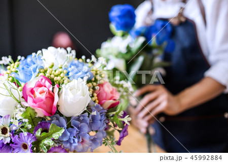 Arranging artificial flowers vest decoration at home, Young woma Arranging artificial flowers vest decoration at home, Young woma 45992884