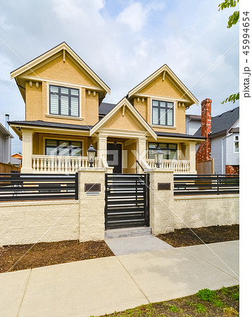 Renovated luxury family house for sale with concrete pathway and metal fence 45994654