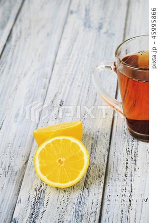 Hot black tea and lemon on table Hot black tea and lemon on table 45995866