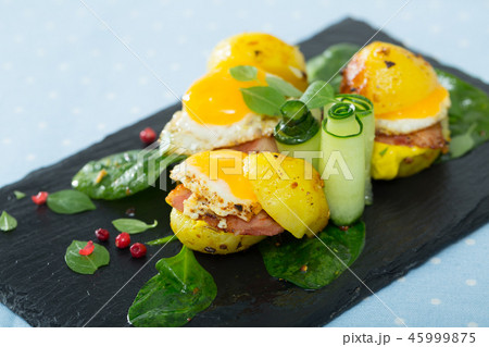 Plate with mini burgers from scrambled quail eggs with potatoes and greens 45999875