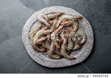 Raw whole fresh uncooked prawns shrimps on stone gray plate, stone background. Top view with copy Raw whole fresh uncooked prawns shrimps on stone gray plate, stone background. Top view with copy 46000748