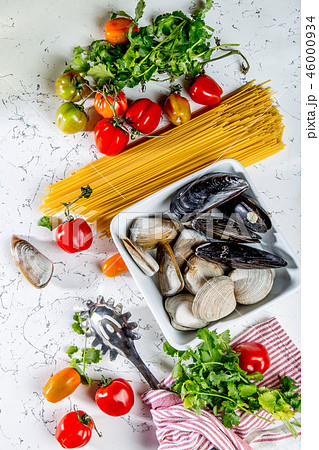Ingredients for cooking Spaghetti with seafood. Shells musselsa, clams, vongole, tomatoes and white Ingredients for cooking Spaghetti with seafood. Shells musselsa, clams, vongole, tomatoes and white 46000934