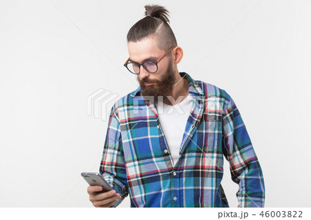 Technologies, fashion and people concept - Cool man with beard using telephone over white background Technologies, fashion and people concept - Cool man with beard using telephone over white background 46003822