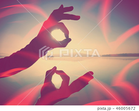 Filtered. Wrist makes ok sign is all right by sea Filtered. Wrist makes ok sign is all right by sea 46005672