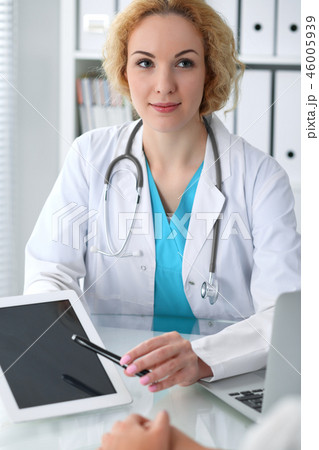 Happy blonde female doctor and patient discussing medical examination results. Medicine, healthcare 46005939