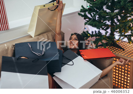 Young woman at home in winter holidays. Christmas and New Year Young woman at home in winter holidays. Christmas and New Year 46006352