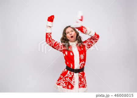 Holiday, Christmas and people concept - Woman in santa costume shouting of joy 46008015
