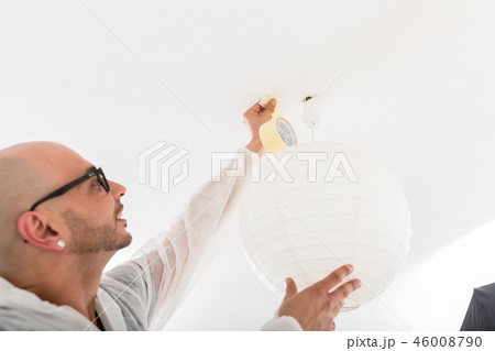 Male decorator fixing the tape on ceiling Male decorator fixing the tape on ceiling 46008790