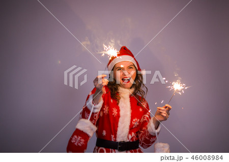 Holidays, party and people concept - smiling christmas woman wearing santa claus suit holding 46008984