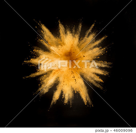 Golden powder explosion on black background. 46009096