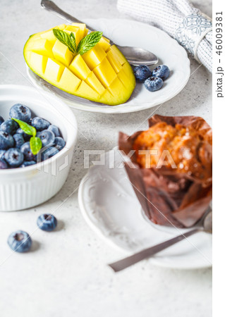 Breakfast served with muffins, juice, berries Breakfast served with muffins, juice, berries 46009381