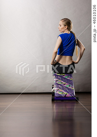 Woman training on bench for sit ups Woman training on bench for sit ups 46010106
