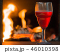 Glass of red wine near fireplace  46010398