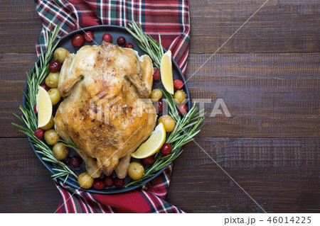 Roasted Chicken with potatoes and rosemary. 46014225